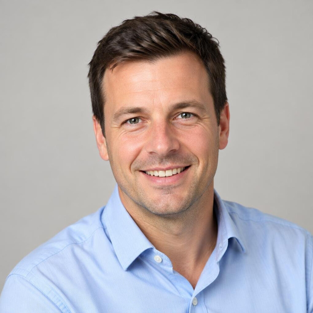Portrait of a man in a light shirt smiling